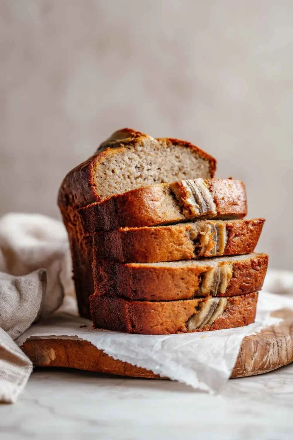gluten-dairy-free-banana-bread-sliced-modern. Sliced gluten dairy free banana bread on wooden board in modern kitchen